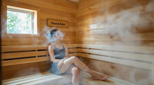 Person resting in warm-lit sauna with 'Natural Relief' on wall plaque