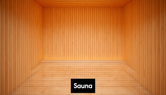 Modern home sauna interior with light wood and benches.